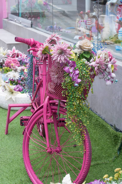 istock Pink bicycle with basket filled flowers 1481399648