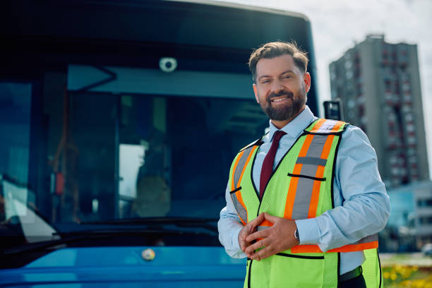 istock Happy public transport driver in front of a bus looking at camera. 1481399730