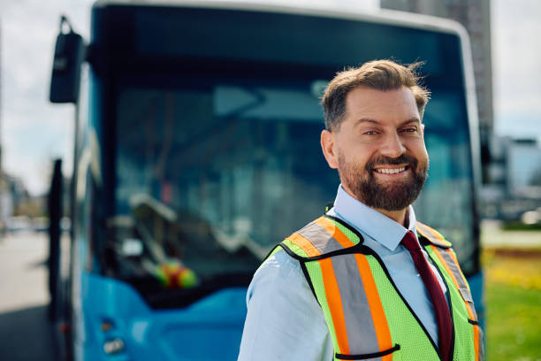 istock Happy bus driver in front of a vehicle looking at camera. 1481399808