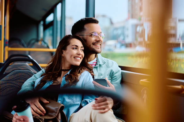 istock Happy couple looking through window while enjoying the ride in a bus. 1481400030