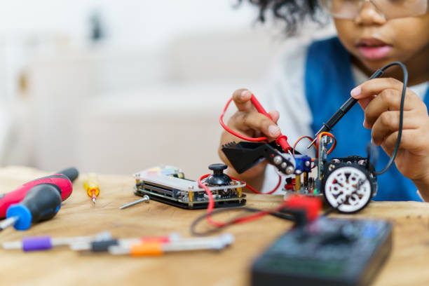 istock Little girl enjoy assembly a robot. 1481400127