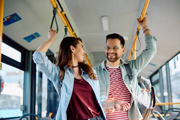 istock Young happy couple talking while riding in a city bus. 1481400407