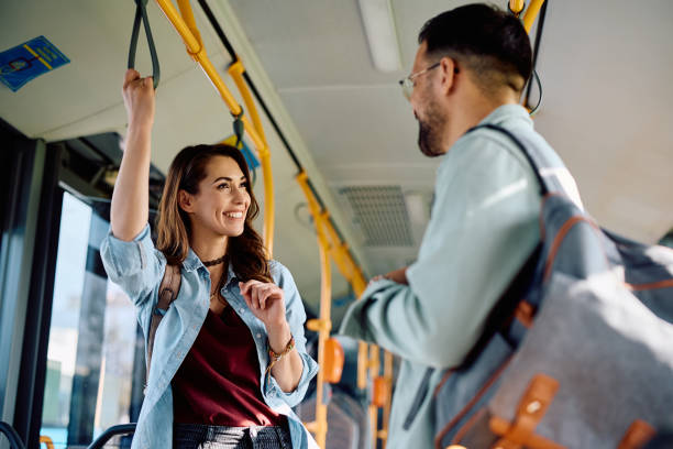 istock Happy woman communicating with her friend while riding in a bus. 1481400410
