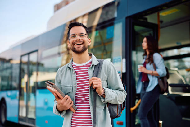 istock Young cheerful student arriving at the bus station. 1481400442