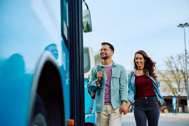 istock Happy couple holding hands while boarding in public transport. 1481400722
