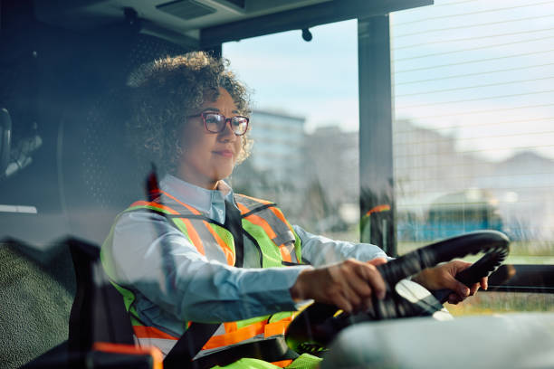 istock Happy female bus driver behind the steering wheel. 1481400795