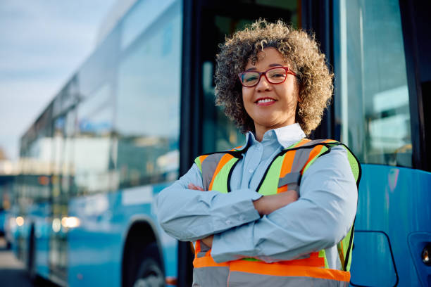 istock Confident woman working as professional bus driver and looking at camera. 1481400896