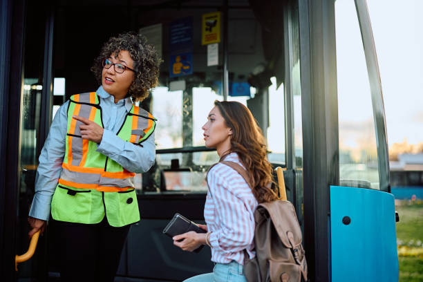 istock Bus driver assisting young woman with a direction at the station. 1481401077