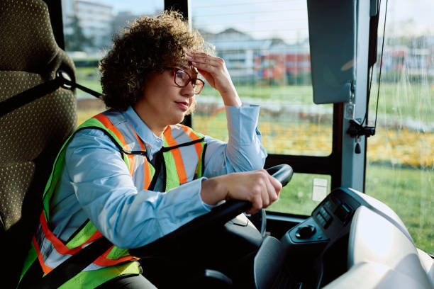 istock Female bus driver having a headache while sitting behind the steering wheel. 1481401111