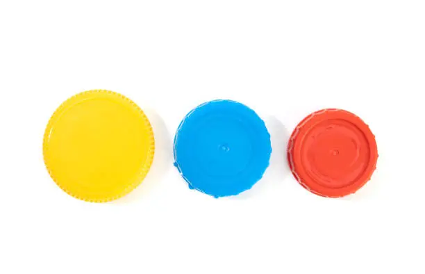 Yellow blue and red plastic screw caps isolated on white background
