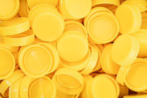 Yellow plastic screw caps background