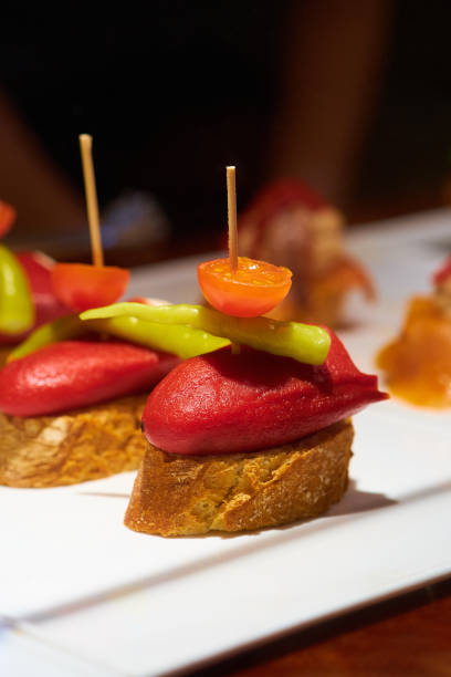 Typical snack from the Basque Country , pinchos or pintxos, ready to eat at the bar, small slices of bread with topping or mix of toppings, San Sebastian, Spain, close up