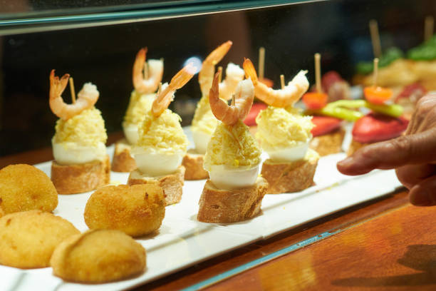 Typical snack from the Basque Country , pinchos or pintxos, ready to eat at the bar, small slices of bread with topping or mix of toppings, San Sebastian, Spain, close up