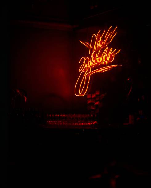 Warsaw, Poland – April 10, 2023: A vibrant red neon sign illuminated in a dark room