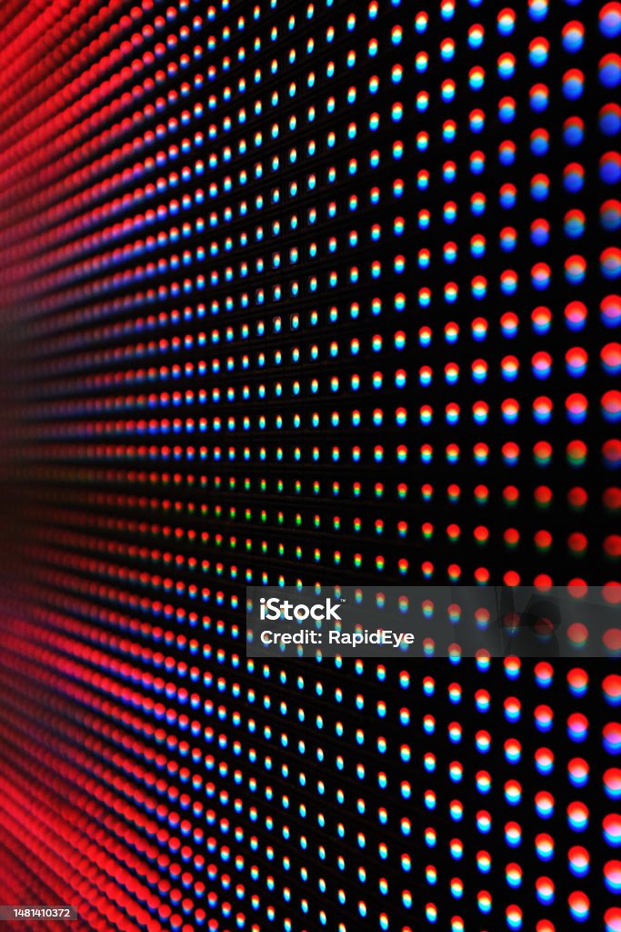 Detail of a modern LED sign showing individual pixels in shades of red and pink Abstract close-up view of a modern electronic billboard with pixels made up by light-emitting diodes. Abstract Stock Photo