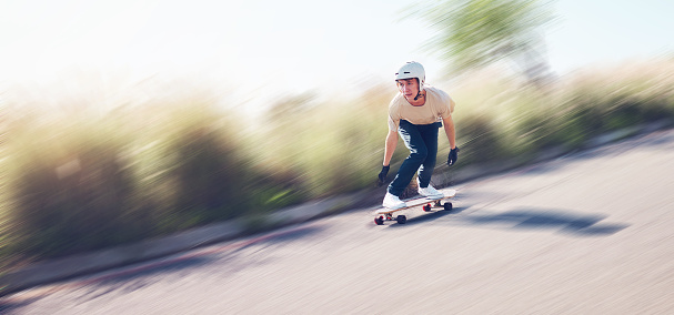 Motion blur, skating and mockup with a sports man training outdoor on an asphalt street at speed. Skateboard, speed and mock up with a male skater on a road for fun, freedom or training outside