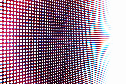 Abstract close-up view of a modern electronic billboard with pixels made up by light-emitting diodes.