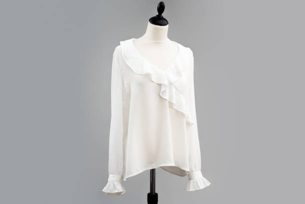 A long sleeve ribbed top sweater hangs on a white and black headless mannequin isolated by a light gray background backdrop.
