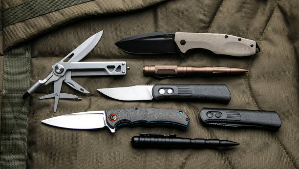 istock Penknives, multi-tools and tactical pens. Folding pocket knives on a khaki background. 1481417303