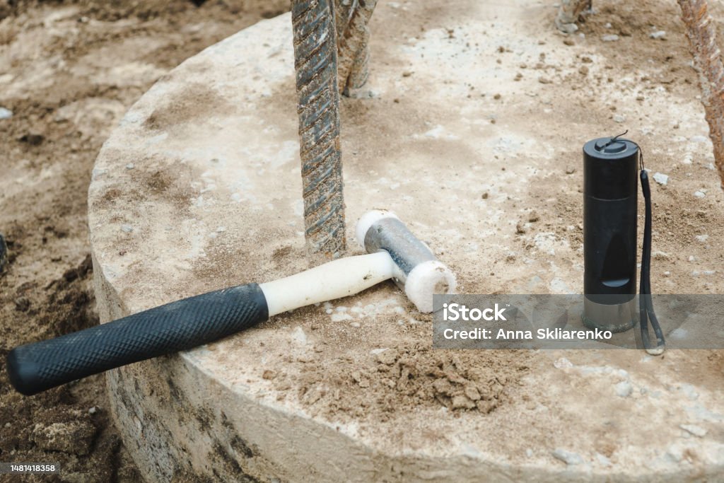 Seismic test on concrete pile. Engineer using the PIT Hand-Held Hammer, the PIT Accelerometer and the Pile Integrity Tester to detect Neck Bulge and Void in the piles Accidents and Disasters Stock Photo