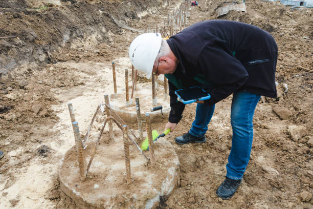 Piles cleaning. Engineer clears a place for pile integrity test. Pile foundation after completed. Reinforced concrete piles of the new building. Concrete pile foundation for new construction site.