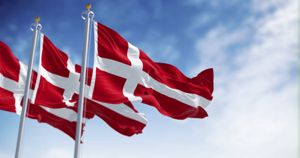 istock Three Denmark national flags waving in the wind on a clear day 1481418448
