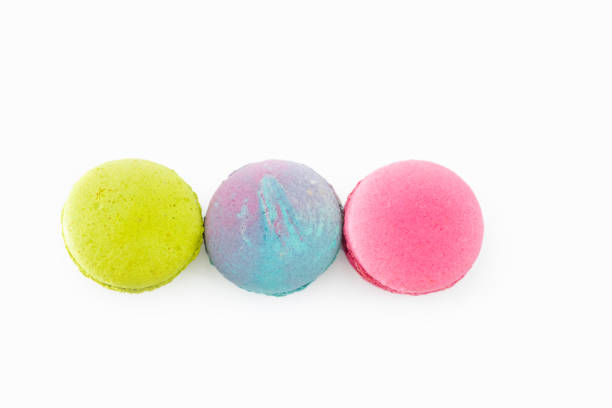 istock Brightly colored French macarons, white background. Tasty colorful macaroon assorted. Three sweet macaroons cakes. Pastry made from egg whites. Concept of food, desserts. Culinary and cooking concept. 1481419746