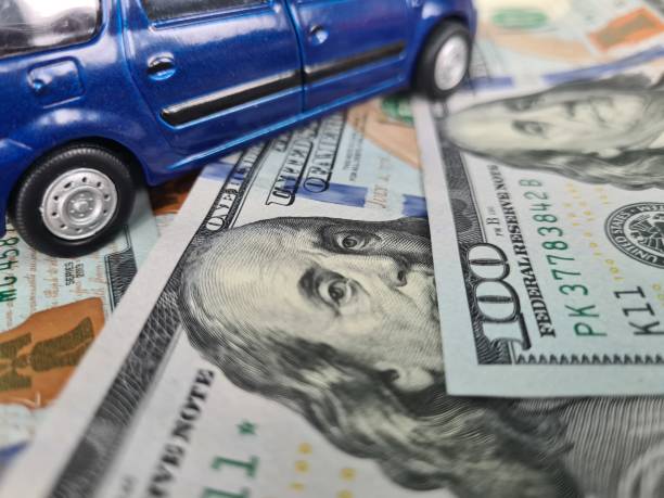 istock Minivan stands on scattered dollars and upgrades car 1481422265