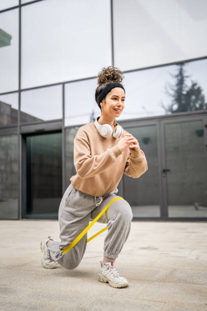 istock One woman training with elastic rubber resistance bands outdoor 1481423413