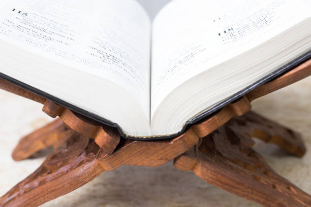 istock Open Bible on ornate wooden stand. 1481423541