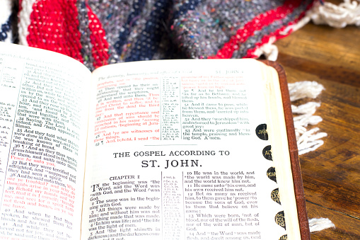 Open Bible on Native American blanket.  Book of John