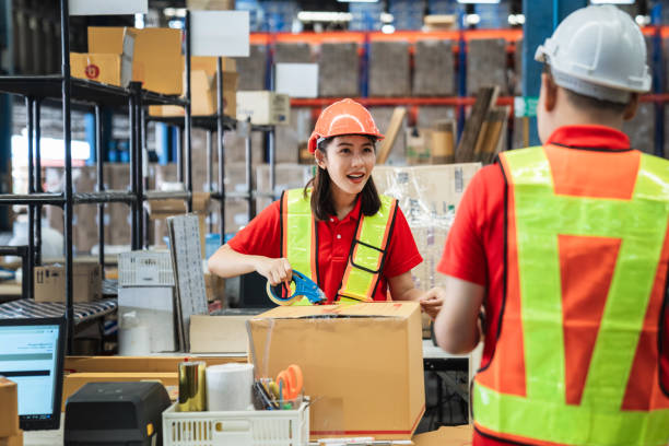 istock Warehouse worker checking details stock product and scanning a barcode on box package in the background warehouse., Industrial and industrial concept. 1481423706