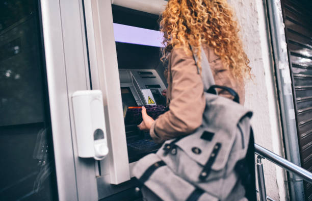 istock Young woman at the ATM machine 1481424022