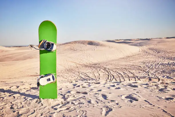 Sandboard, sports and nature with desert sand, dunes and hills with no people and sport equipment. Exercise, fitness, and mockup of deserted landscape in Dubai with bike tracks and mock up space