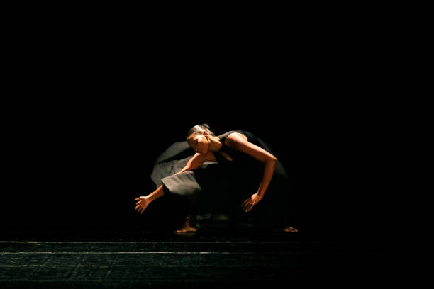istock Black young woman performing contemporary dance on dark stage 1481425549