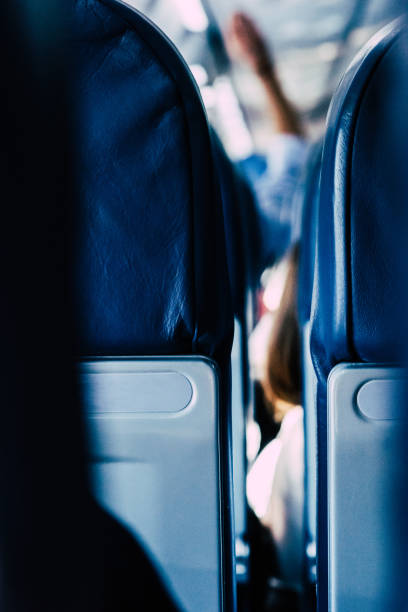 istock Interior of empty modern aircraft with blue flight seats and hallway in daytime during flight 1481425552