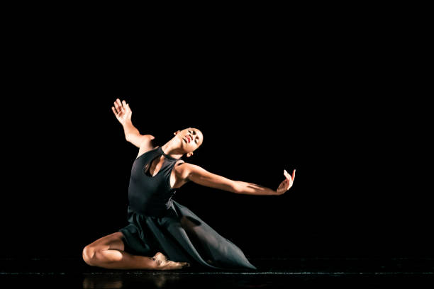 istock Black young woman performing contemporary dance on dark stage 1481425587