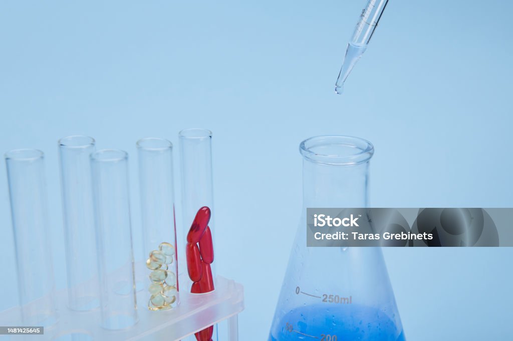Focus On Drops With Blue Solution Dripping From A Graduated Pipette ...