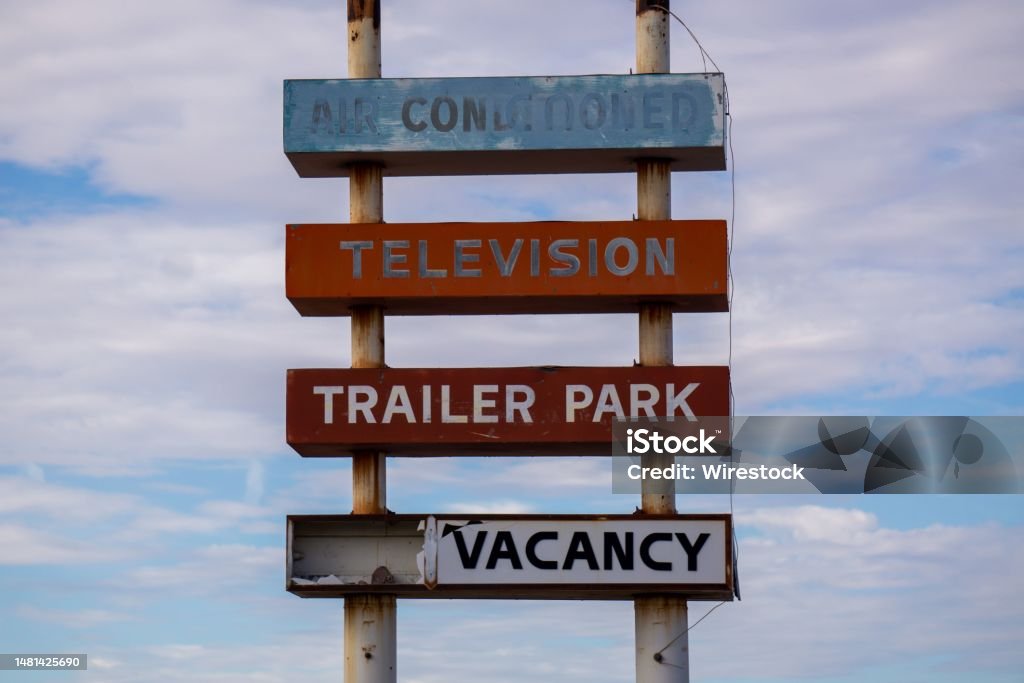 Fading, decrepit old trailer park sign for a long-gone trailer park in the California desert. A fading, decrepit old trailer park sign for a long-gone trailer park in the California desert. Abandoned Stock Photo