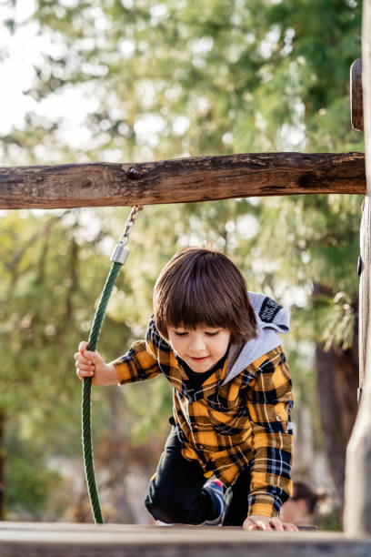 istock Child climbing up in rope park 1481430102