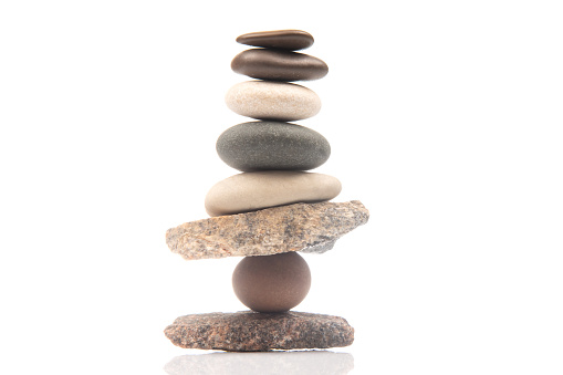 Stacks of stones on a white background, front view. Zen like concepts. Stone podium for product presentation and branding. Spa stones treatment.