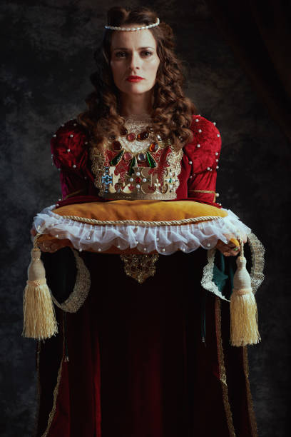 istock medieval queen in red dress with crown on pillow 1481430444
