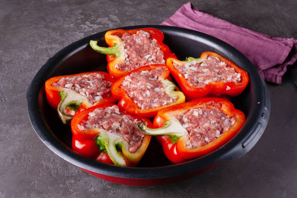 istock round frying pan with stuffed raw pepper on a gray background 1481430536