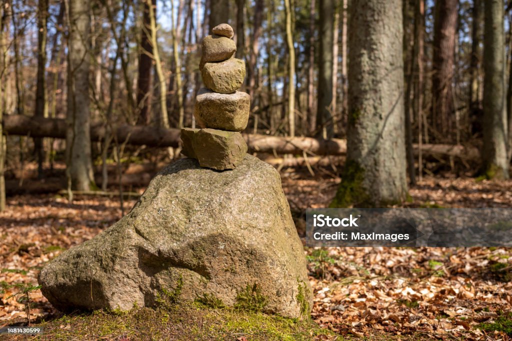 Zen Stones Stacked Stones Forest Nature Stone boulders stacked to form a zen tower at day in the forest in sunshine. 2023 Stock Photo