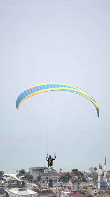 Rear view of man preparing to fly with paraglider