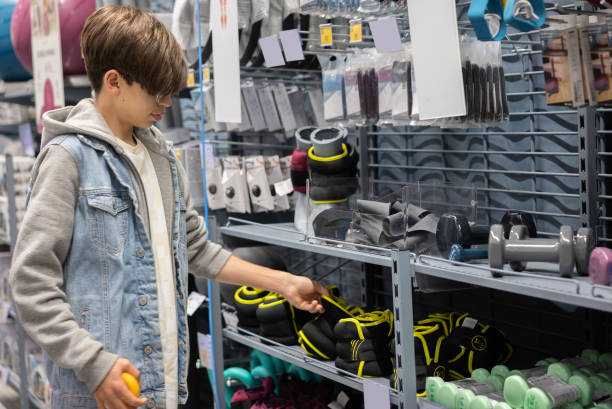 istock Young boy choosing weights from sports store 1481434070