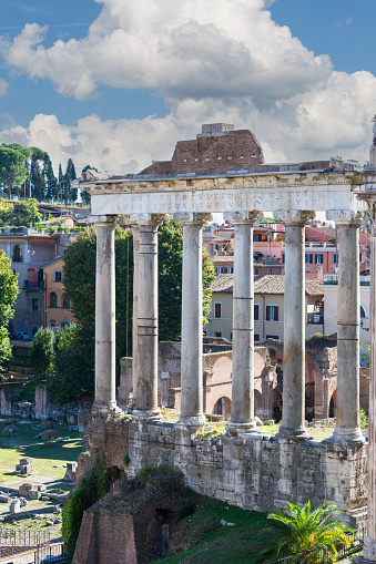 View of ongoing archaeological excavations at the Forum of Augusts in ancient Rome, with Trajan's forum and Trajan's column visible to the left, and Casa dei Cavalieri di Rodi on the right.