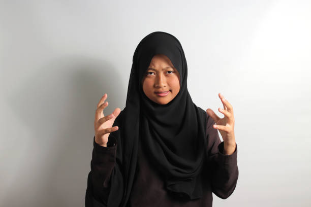 istock Angry young Asian girl in hijab shouting 1481436175