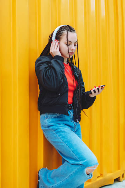 istock Sad young woman using mobile and headphones 1481437169