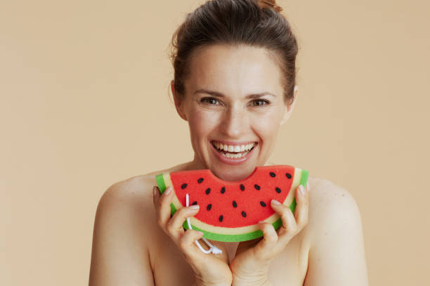 istock smiling modern female with watermelon shower sponge 1481439287